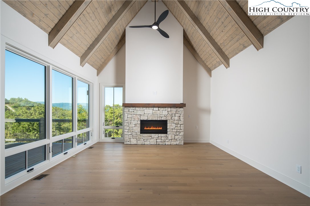 359 Calico Court Boone, NC 28607 - Photo 2 of 50 an empty room with fireplace and windows
