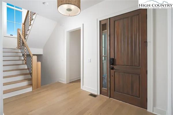 a view of entryway with wooden floor