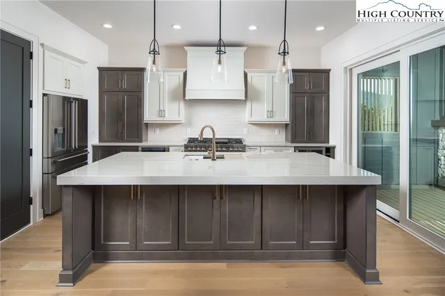 a kitchen with a sink refrigerator and cabinets