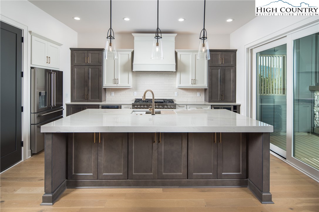 359 Calico Court Boone, NC 28607 - Photo 8 of 50 a kitchen with a sink refrigerator and cabinets