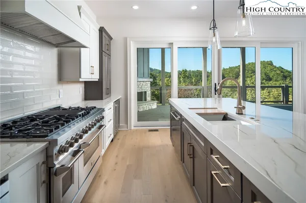 a kitchen with a sink and a large window
