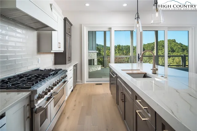 a kitchen with a sink and a large window