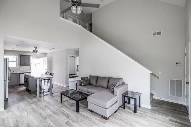 a living room with furniture and a wooden floor
