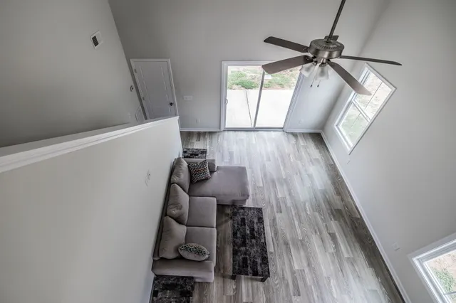 a view of a room with wooden floor and staircase