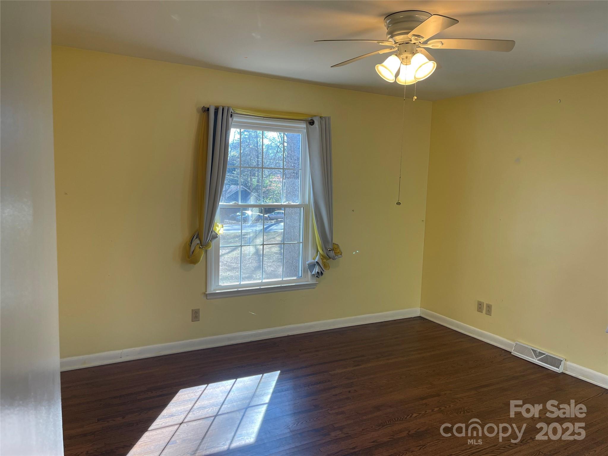 14701 Beckenham Drive Charlotte, NC 28227 - Photo 15 of 19 a view of an empty room with wooden floor and a window