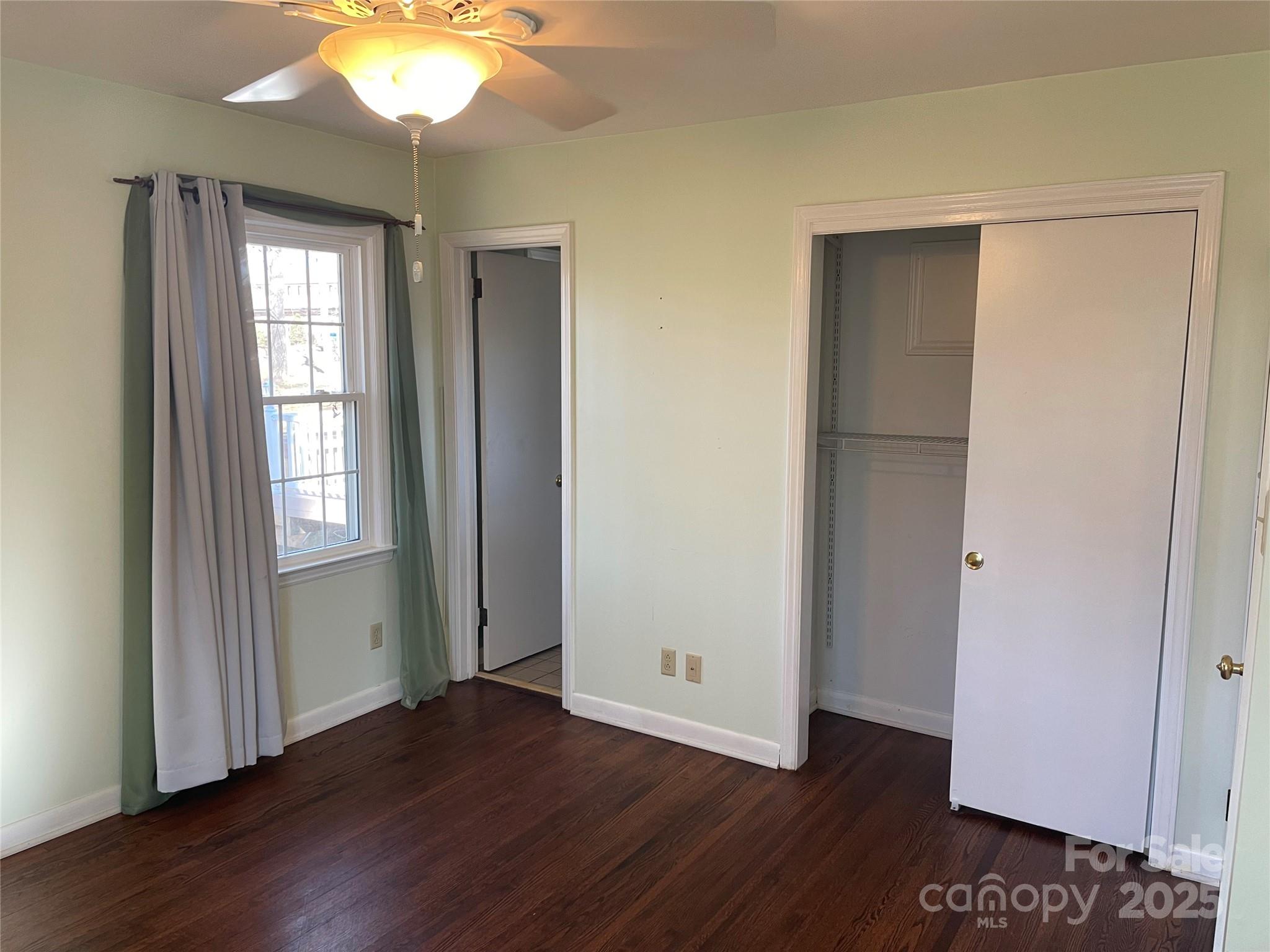 14701 Beckenham Drive Charlotte, NC 28227 - Photo 16 of 19 an empty room with wooden floor and windows