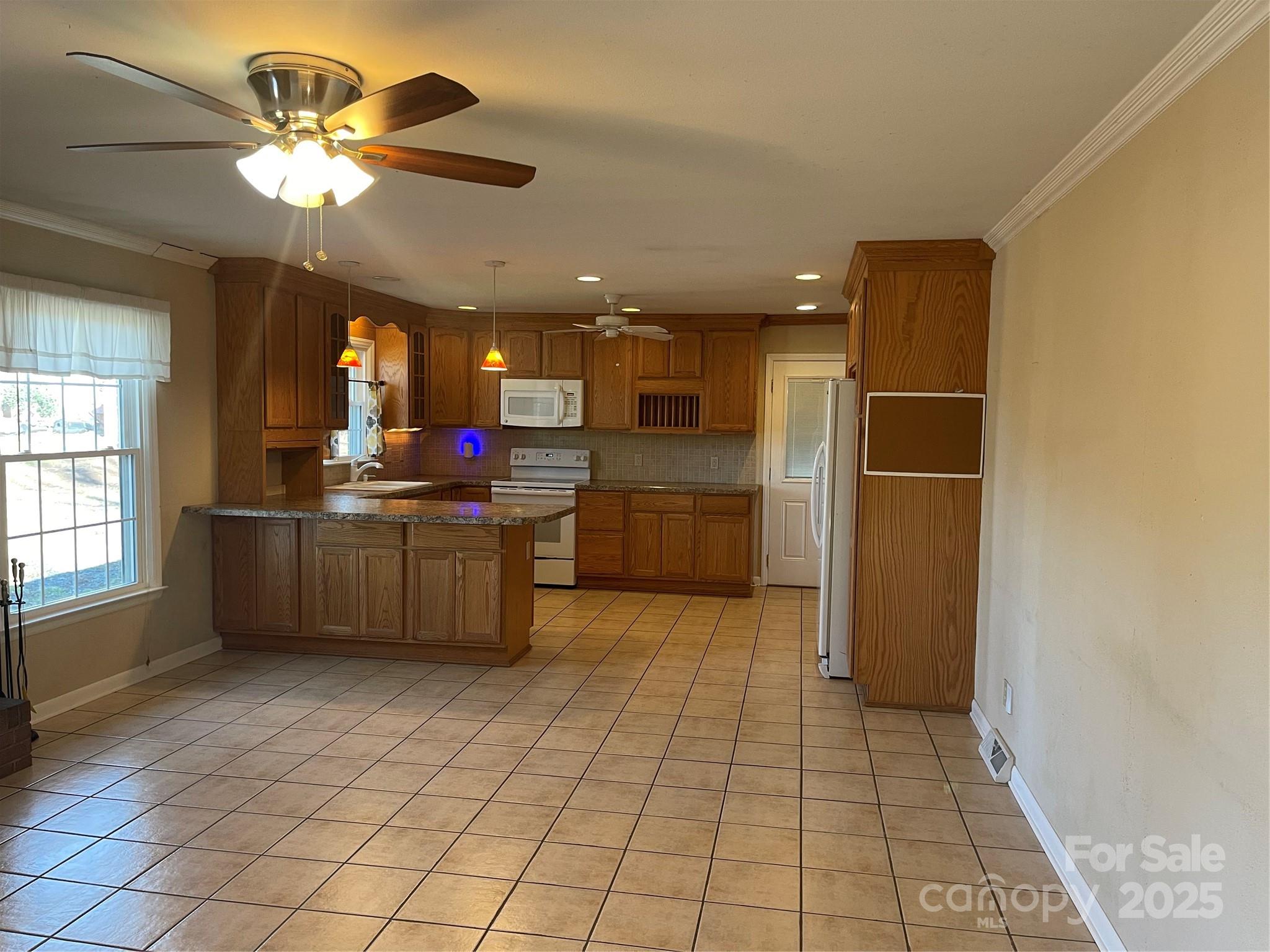 14701 Beckenham Drive Charlotte, NC 28227 - Photo 7 of 19 a kitchen with kitchen island granite countertop a refrigerator and a sink