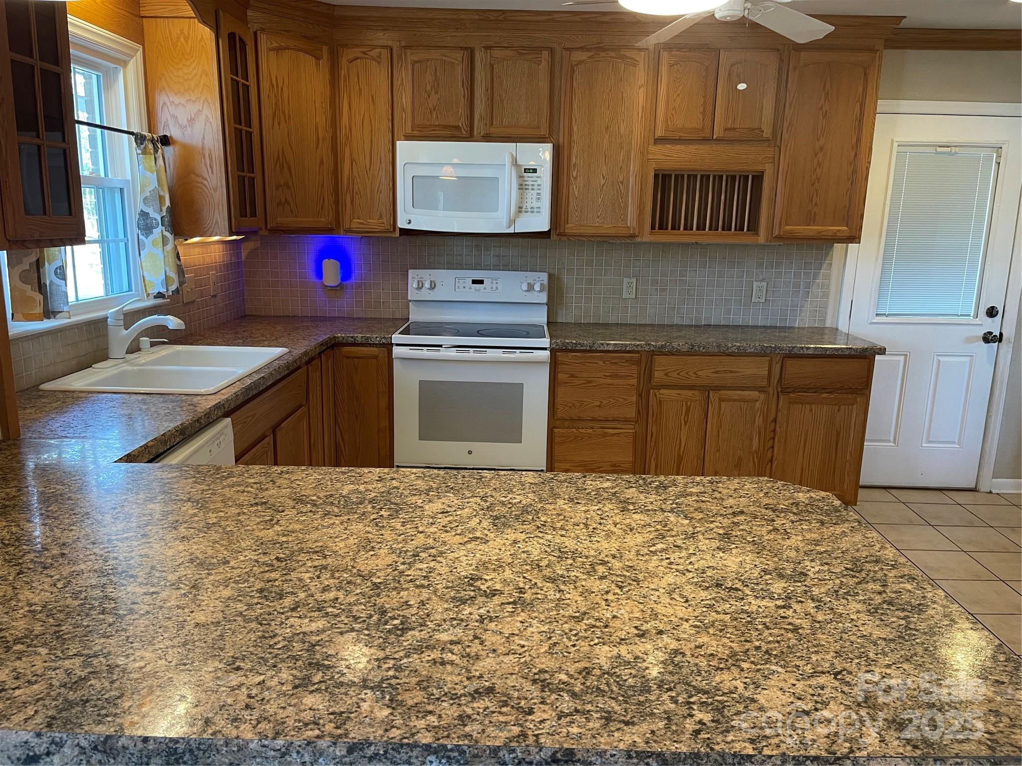 14701 Beckenham Drive Charlotte, NC 28227 - Photo 9 of 19 a kitchen with stainless steel appliances granite countertop a stove a sink and a microwave