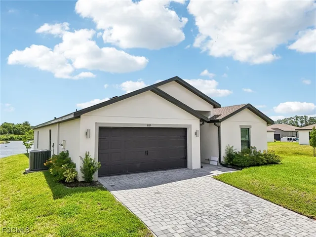 a view of a house with a yard and a garden