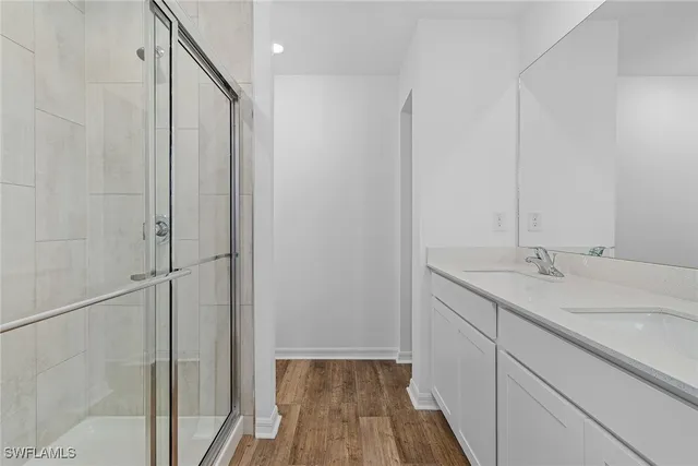 a bathroom with a double vanity sink and mirror