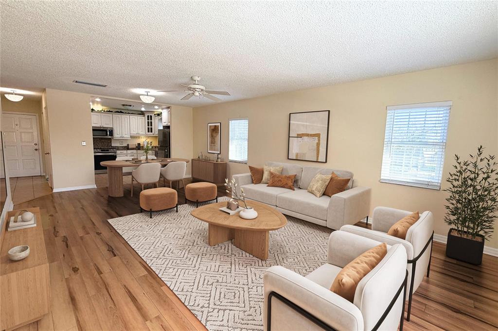 701 Poinsettia Road, Unit 340 Belleair, FL 33756 - Photo 3 of 24 a living room with furniture and a dining table with wooden floor