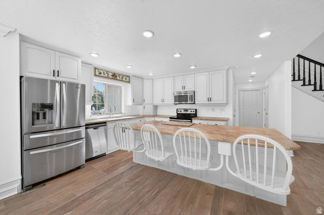 883 East 700 South Springville, UT 84663 - Photo 13 of 59 Kitchen featuring white cabinetry with dark hardware, a stainless steel French door refrigerator, and a built-in microwave