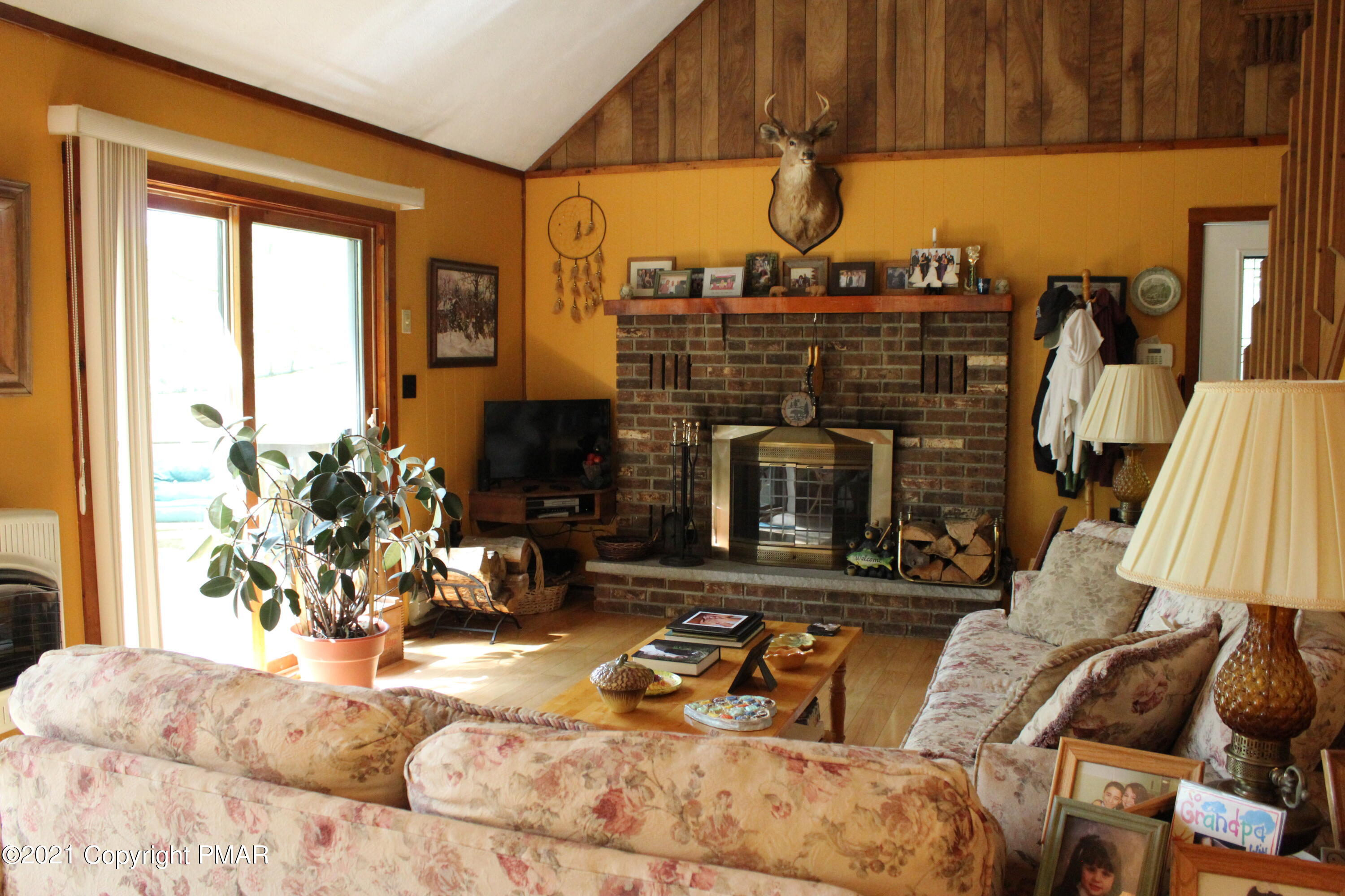 4208 Winchester Way Bushkill, PA 18324 - Photo 12 of 44 a living room with furniture a fireplace and a window