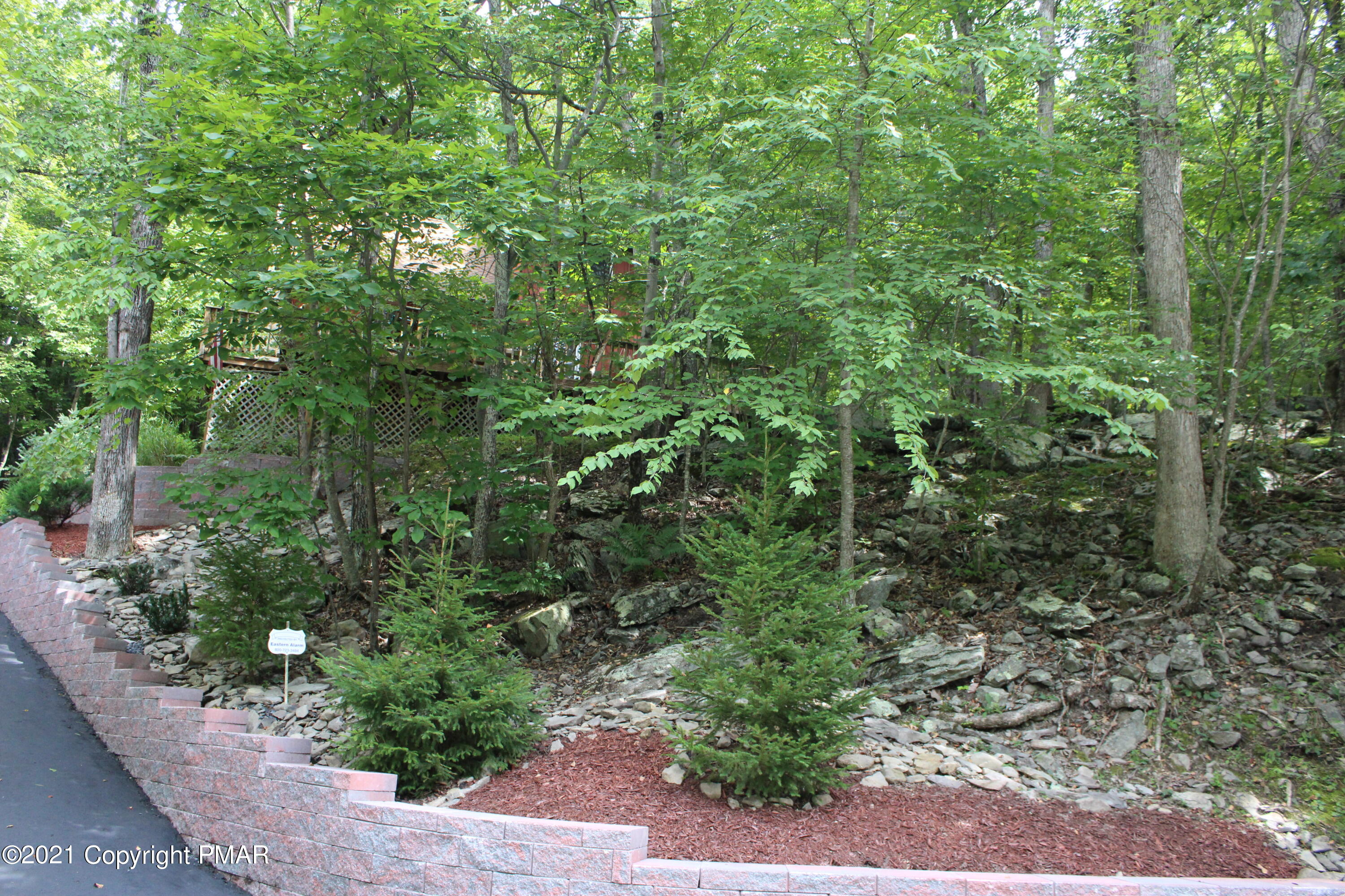 4208 Winchester Way Bushkill, PA 18324 - Photo 27 of 44 a view of a garden with plants and large trees