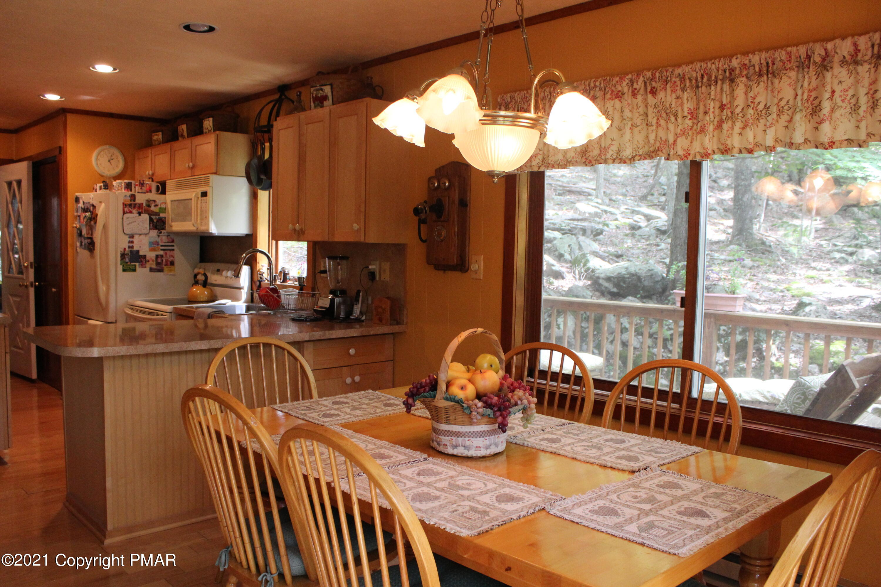 4208 Winchester Way Bushkill, PA 18324 - Photo 5 of 44 a view of a dining room with furniture a chandelier and large windows