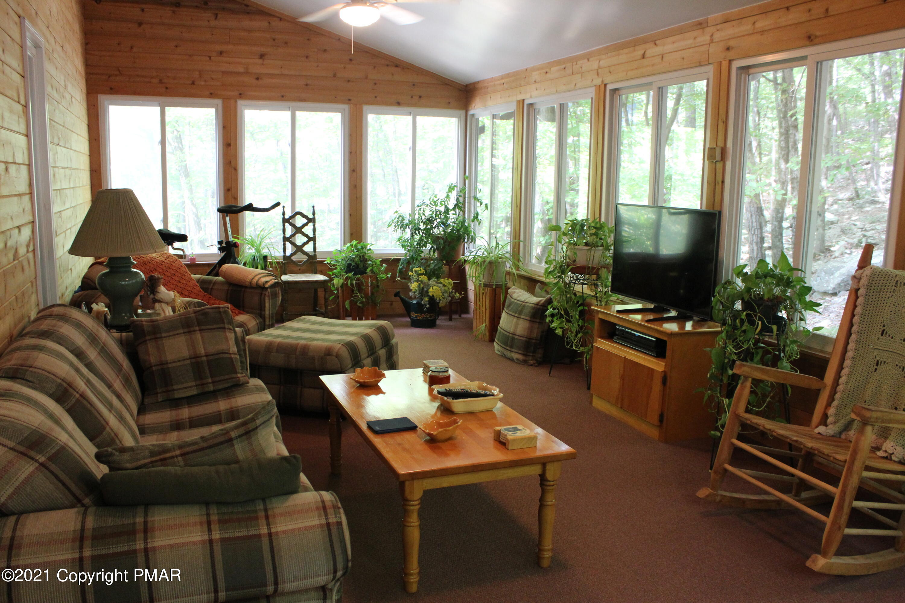 4208 Winchester Way Bushkill, PA 18324 - Photo 8 of 44 a living room with furniture and a floor to ceiling window
