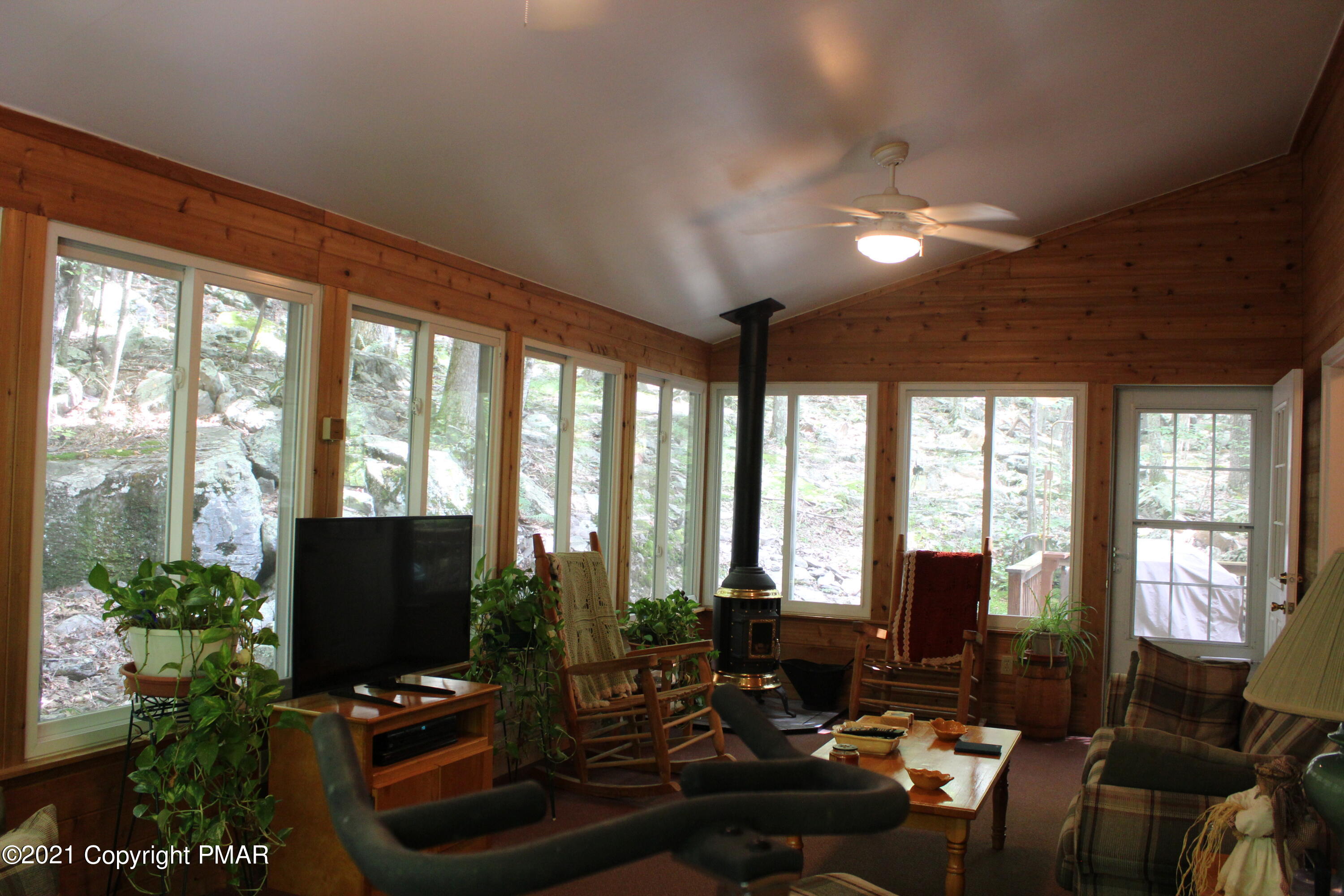 4208 Winchester Way Bushkill, PA 18324 - Photo 9 of 44 a living room with patio furniture and a flat screen tv