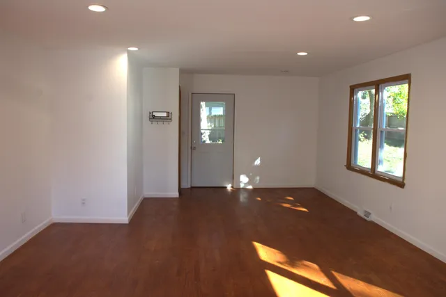an empty room with windows and closet