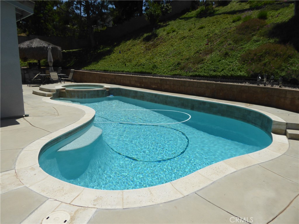 17115 Noble View Circle Riverside, CA 92503 - Photo 41 of 50 Pool Area showing the Pool Sweep cleaning the Pool. All Pool Equipment will stay.