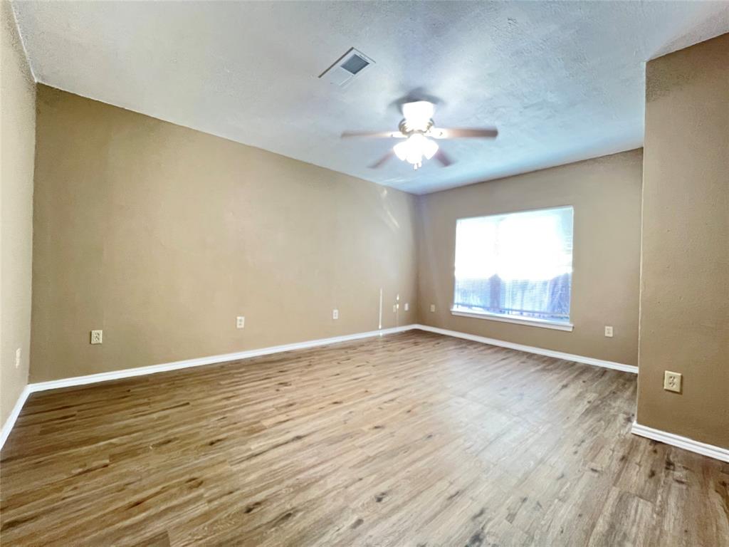 503 Pierce Street Denton, TX 76201 - Photo 9 of 12 wooden floor in an empty room with a window