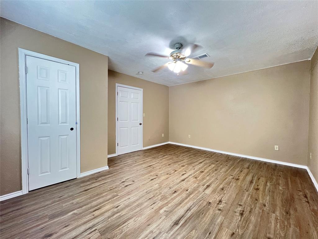 503 Pierce Street Denton, TX 76201 - Photo 10 of 12 a view of empty room with wooden floor and ceiling fan
