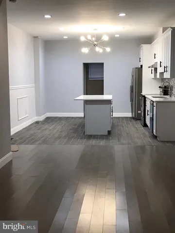 a view of kitchen with cabinets