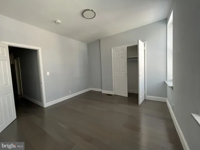 a view of a small space with wooden floor and a window