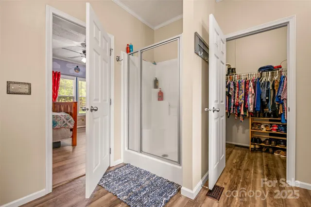 a view of walk in closet with clothes and shoes