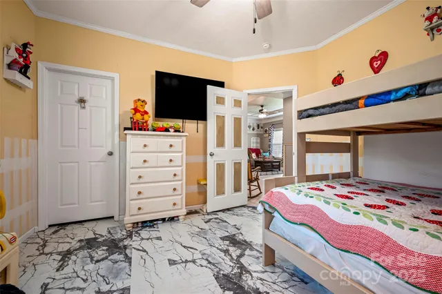 a bedroom with a bed and flat screen tv