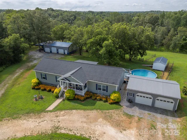 an aerial view of a house with garden space and street view