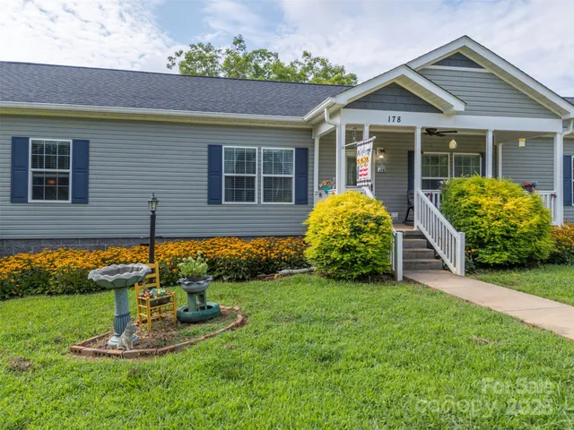 a view of a house with a yard and plants
