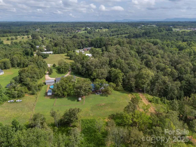 an aerial view of a houses with a yard