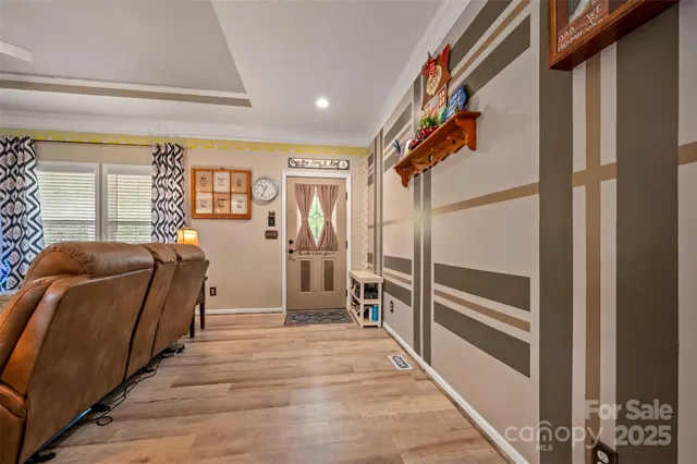 a view of hallway with stairs and wooden floor