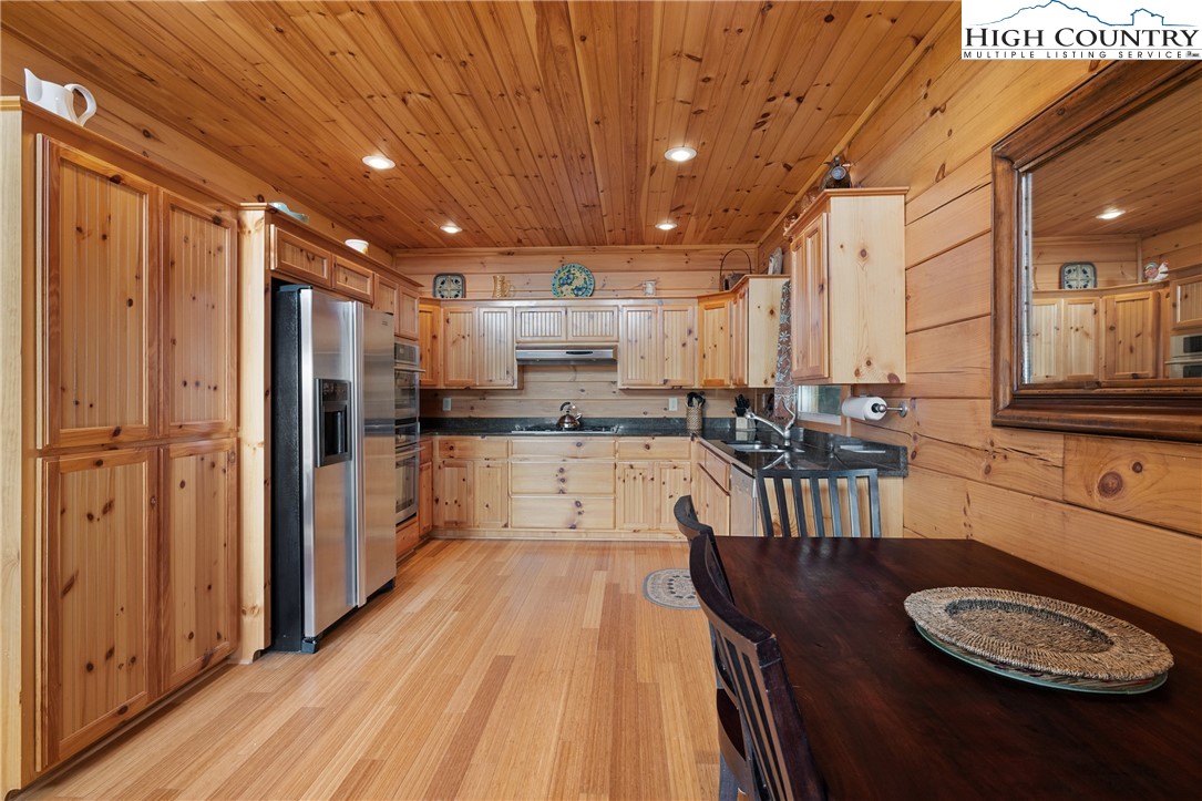 4923 Staghorn Road Purlear, NC 28665 - Photo 18 of 49 a kitchen with stainless steel appliances granite countertop a sink refrigerator and cabinets