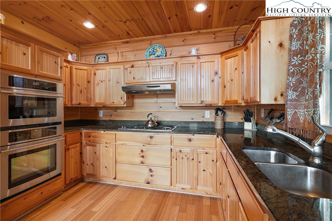 4923 Staghorn Road Purlear, NC 28665 - Photo 20 of 49 a kitchen with stainless steel appliances granite countertop a sink a stove and cabinets