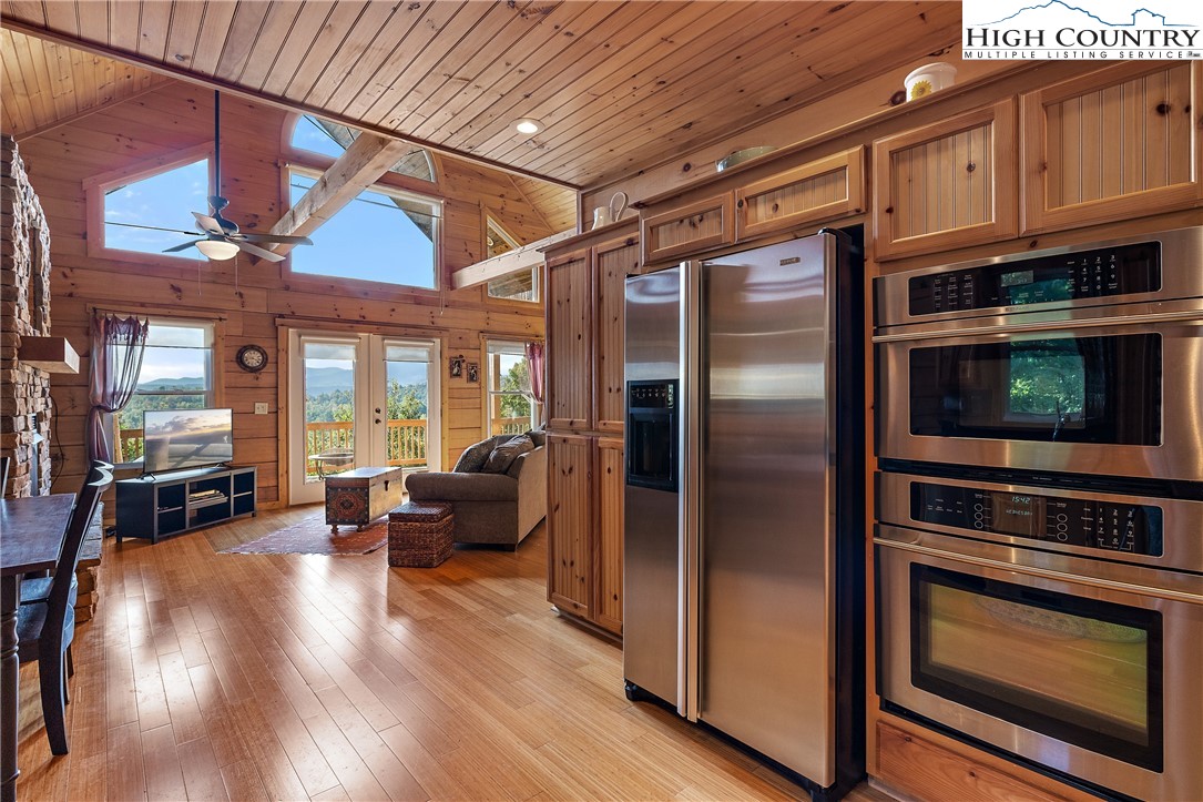 4923 Staghorn Road Purlear, NC 28665 - Photo 21 of 49 a kitchen with stainless steel appliances granite countertop a refrigerator stove and wooden floor