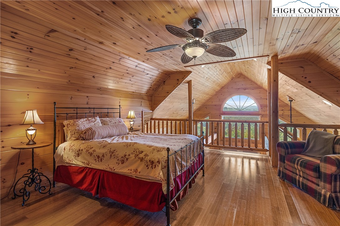 4923 Staghorn Road Purlear, NC 28665 - Photo 23 of 49 a bedroom with a bed and a chandelier