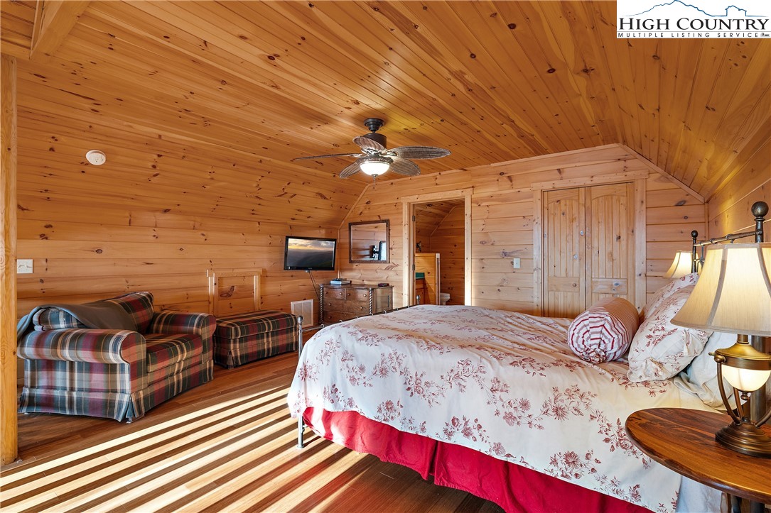 4923 Staghorn Road Purlear, NC 28665 - Photo 24 of 49 a spacious bedroom with a bed and wooden floor