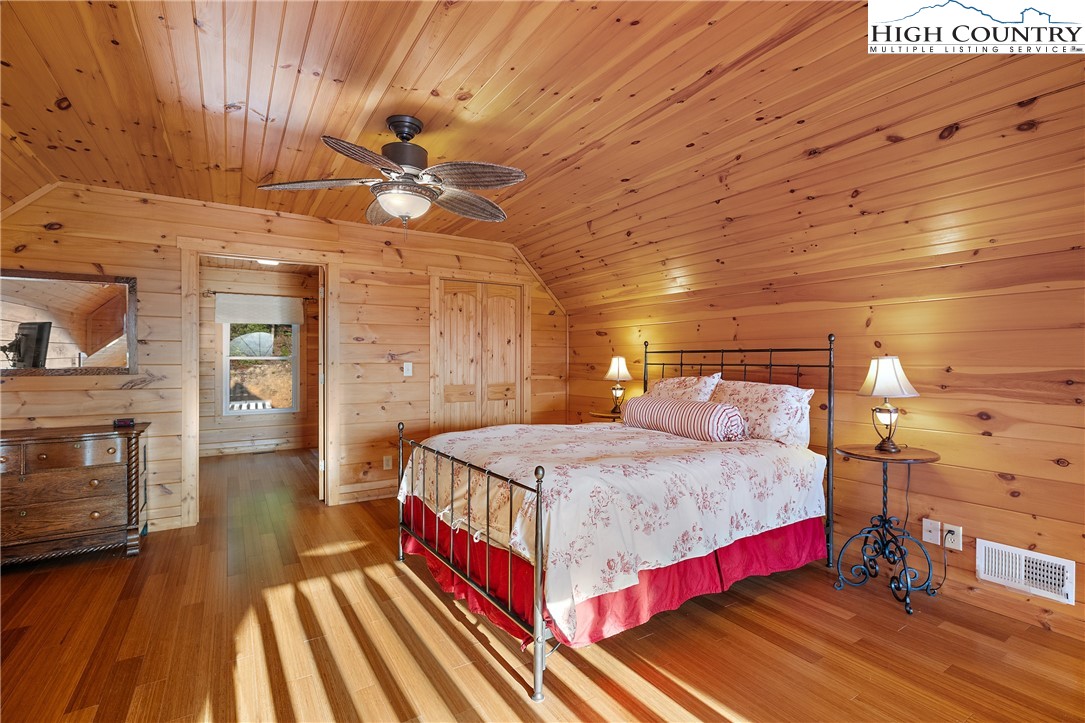 4923 Staghorn Road Purlear, NC 28665 - Photo 25 of 49 a bedroom with a bed and a chandelier