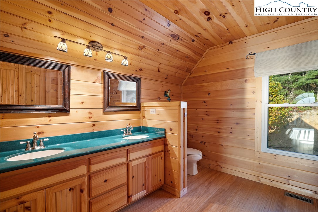 4923 Staghorn Road Purlear, NC 28665 - Photo 27 of 49 a bathroom with a granite countertop sink and a large mirror