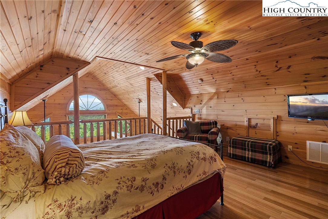 4923 Staghorn Road Purlear, NC 28665 - Photo 29 of 49 a bedroom with a bed next to a window with pc on the wall