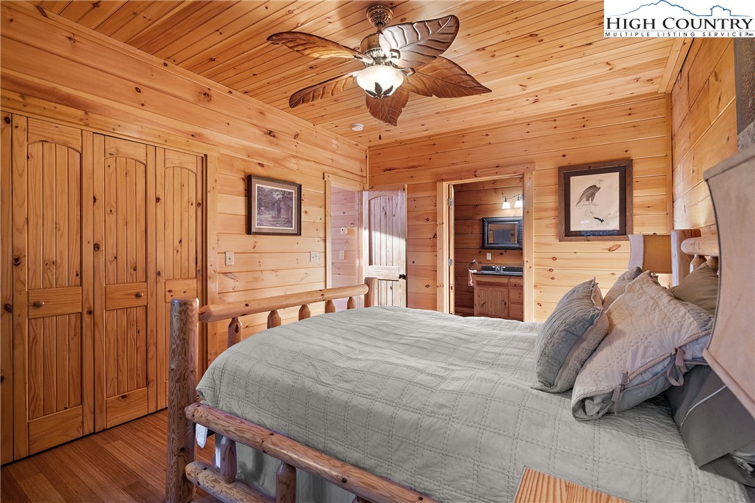 4923 Staghorn Road Purlear, NC 28665 - Photo 31 of 49 a bedroom with a bed and a chandelier