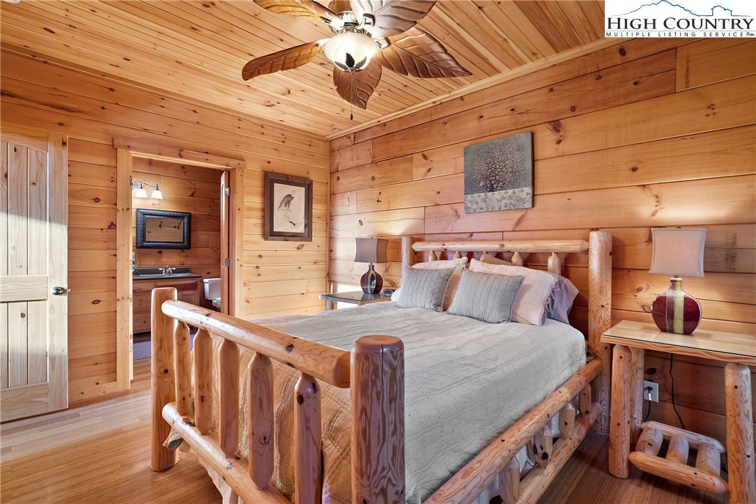 4923 Staghorn Road Purlear, NC 28665 - Photo 32 of 49 a bedroom with furniture and a chandelier