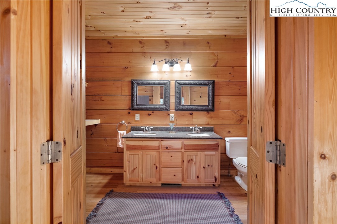 4923 Staghorn Road Purlear, NC 28665 - Photo 33 of 49 a bathroom with a granite countertop sink and a mirror