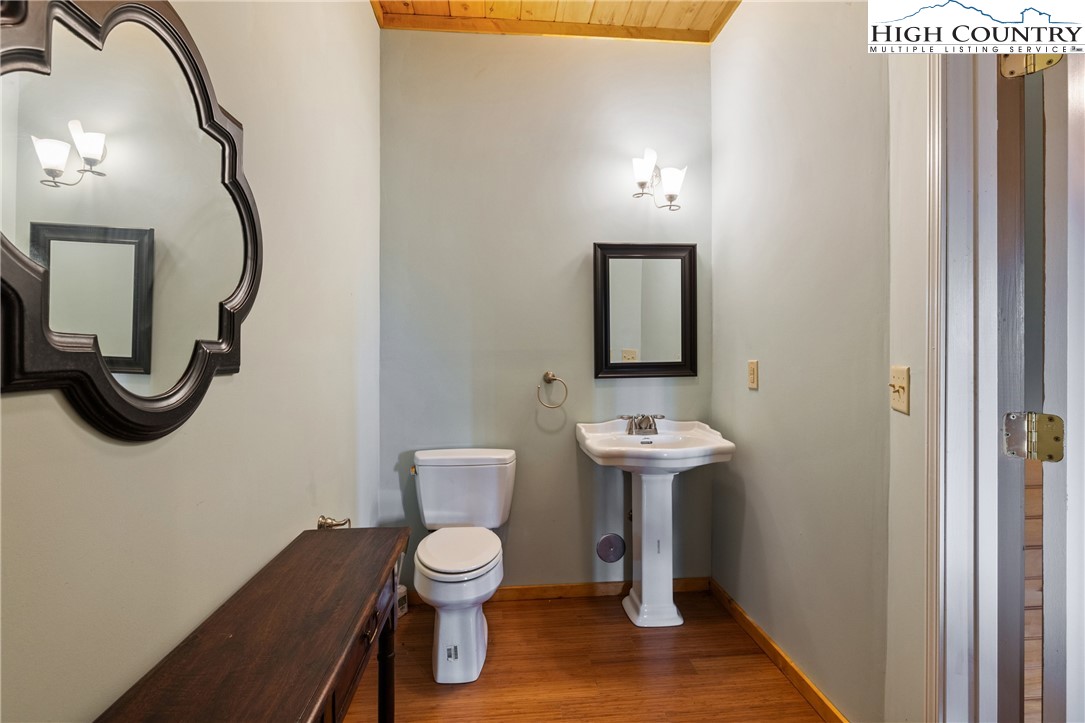 4923 Staghorn Road Purlear, NC 28665 - Photo 36 of 49 a bathroom with a toilet a sink and mirror