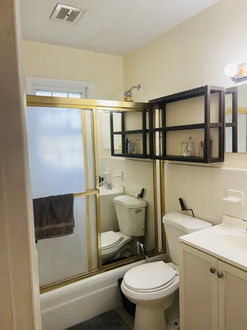 a bathroom with a toilet sink and shower