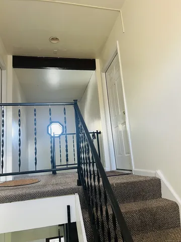 a view of staircase with wooden floor and stairs