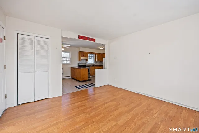 a view of a livingroom with wooden floor and a window