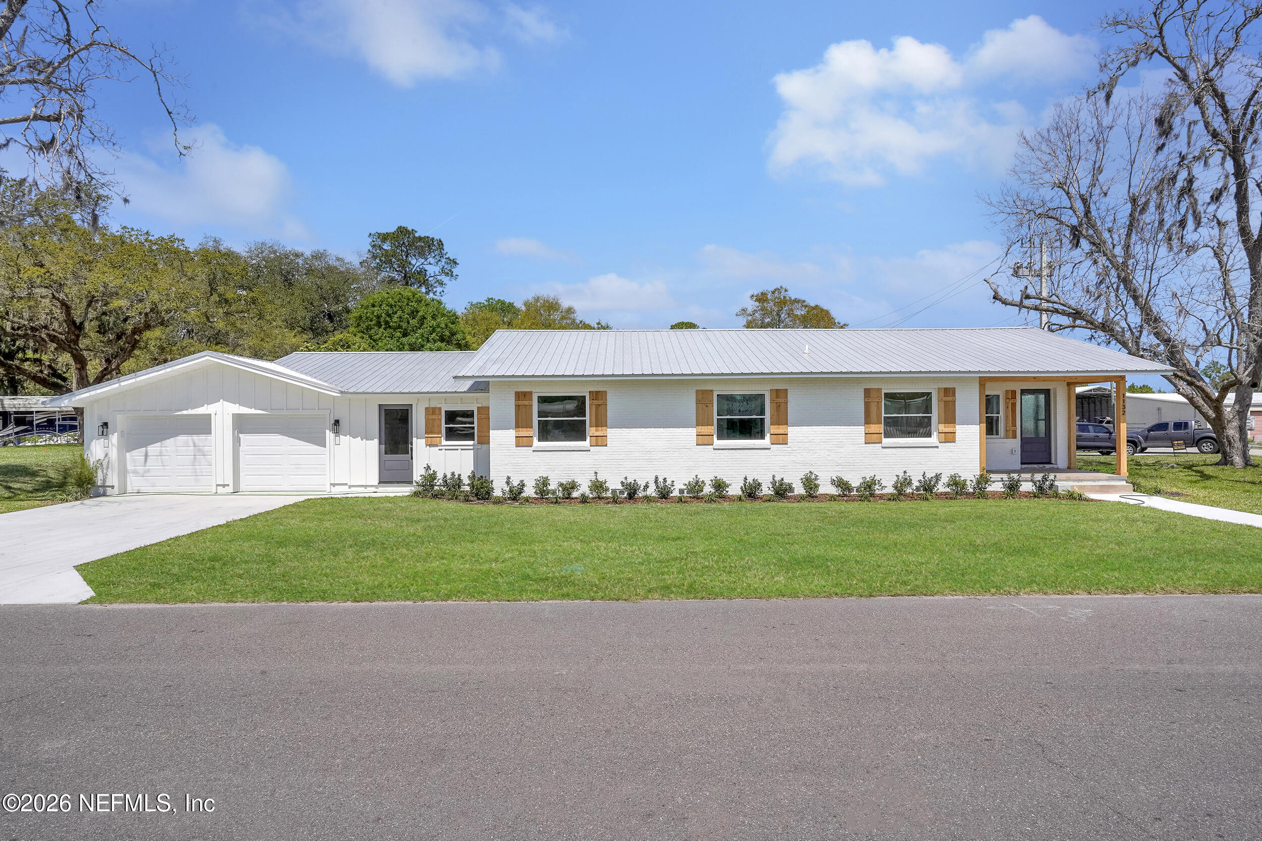 1132 5th Street St. Augustine, FL 32095 - Photo 1 of 34 a front view of a house with a garden