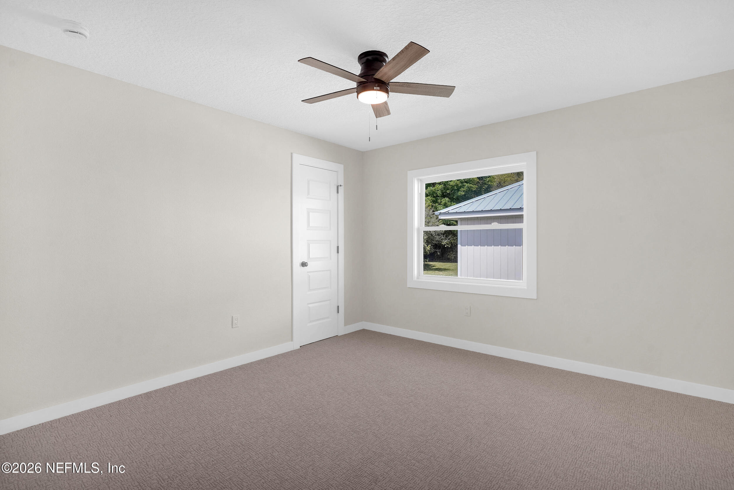 1132 5th Street St. Augustine, FL 32095 - Photo 19 of 34 an empty room with ceiling fan and window